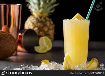 Cocktail with pineapple, coconut and lemon on stone background