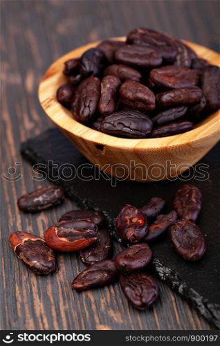 Cocoa beans on a wooden table. Cocoa beans