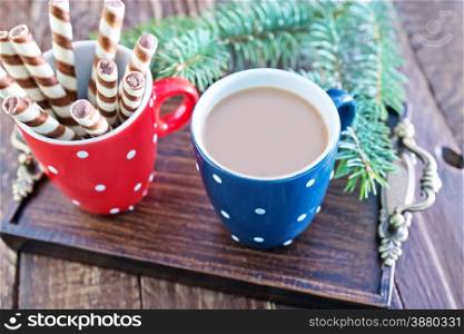 cocoa drink and biscuit sticks on a table