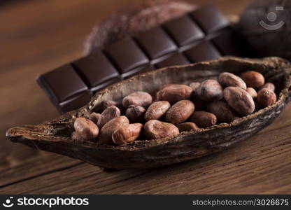 Cocoa pod and cocoa beans on the wooden table. Cocoa pod on wooden background