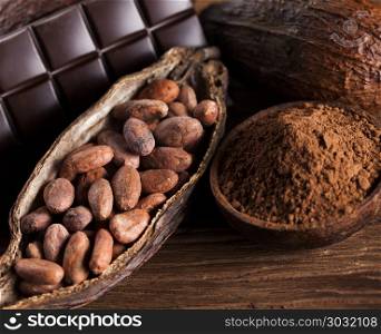 Cocoa pod and cocoa beans on the wooden table. Cocoa pod on wooden background