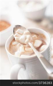 cocoa with small marshmallows in spoon