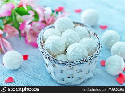 coconut balls in white basket and on a table