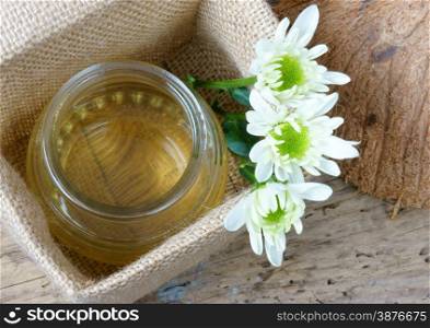 Coconut oil, essential oil from nature, a skin care that safe, rich vintamin, use in massage at spa, organic cosmetic on wooden background