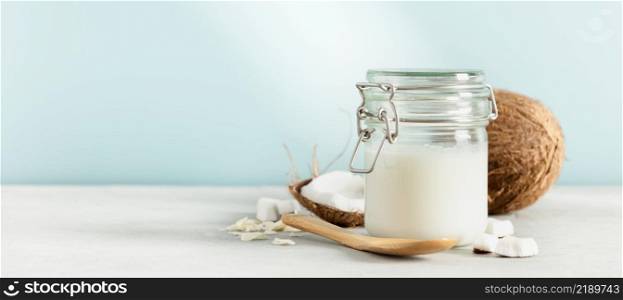 Coconut oil in jar with fresh coconut, Spa cosmetic and food ingredient, banner