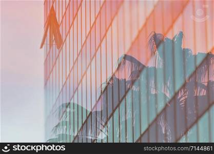 Coconut trees on sunset light and office building. double exposure