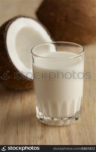 Coconut with a glass of fresh coconut milk
