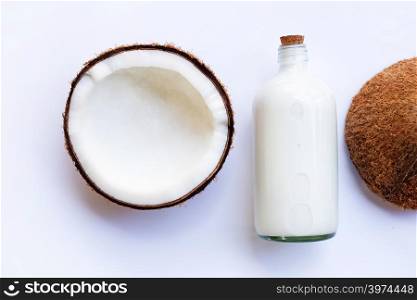 Coconut with coconut milk on white background
