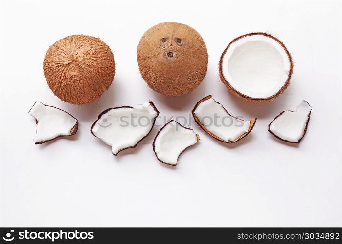 Coconuts on a white background. . Coconuts on a white background. Top view.