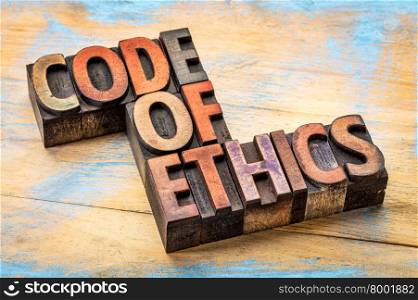 code of ethics banner - word abstract in letterpress wood type printing blocks stained by inks