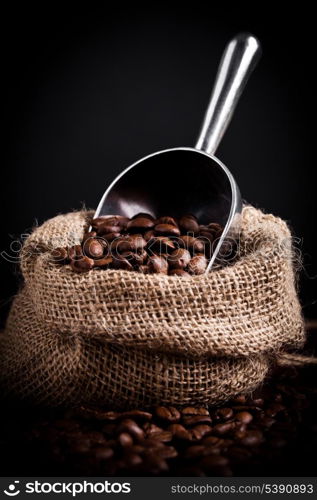 Coffe beans spilling from burlap bag