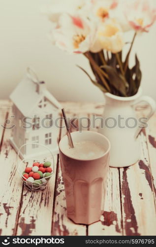 Coffe Latte and tulips on the shabby chic table. The Coffe Latte