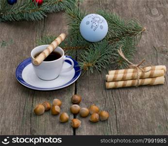 coffee, a fir-tree branch with Christmas tree decorations, nutlets, a subject holidays Christmas and New Year