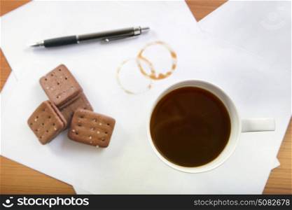 Coffee and biscuits on desk