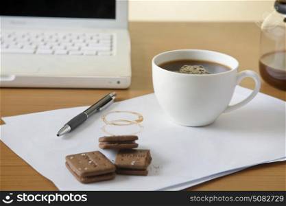 Coffee and biscuits on desk