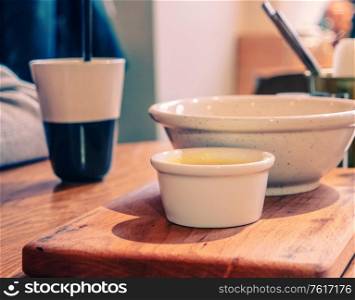 Coffee and bowls of food on table top. Vintage color Image.. Coffee and bowls of food on table