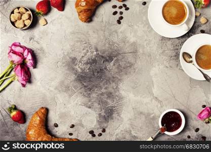 Coffee and croissants on grey stone background. Top view. Flat lay style.
