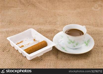 Coffee and egg roll on linen background
