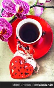 Coffee and Orchid flower. Red Cup decorated with symbolic hearts with black coffee and a flowering branch of orchids