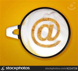 coffee art, A cup of cappuccino with email sign on yellow background. . coffee art