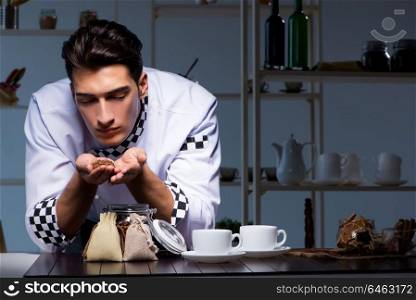 Coffee barista working late in shop preparing drinks