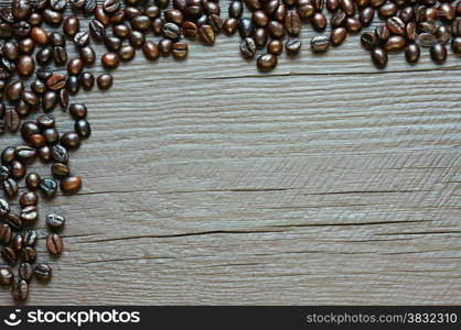 Coffee bean background on wooden texture, brown cafe beans and grey color can make amazing, simple frame