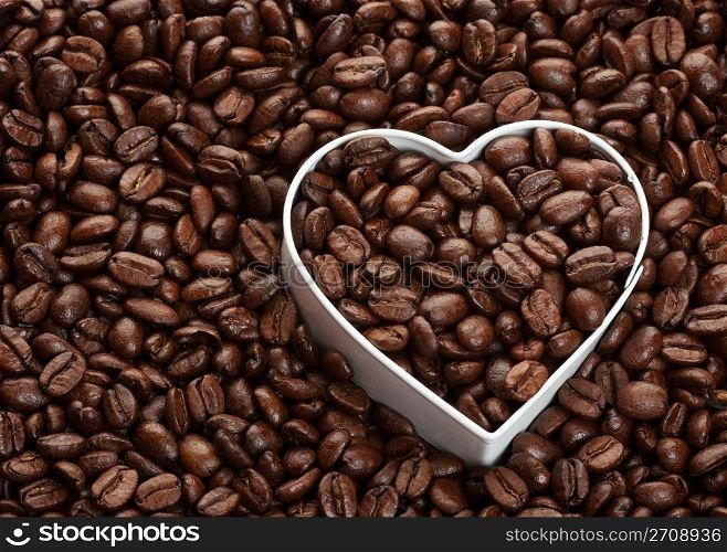 Coffee bean background with heart shape. Coffee lovers concept.
