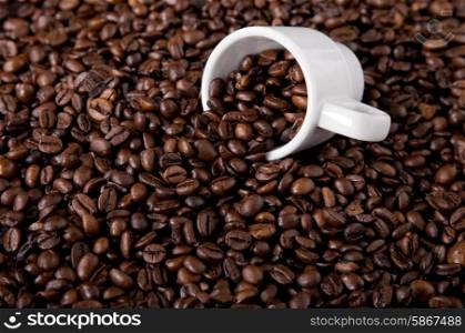 coffee beans and a white coffee cup
