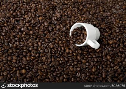 coffee beans and a white coffee cup