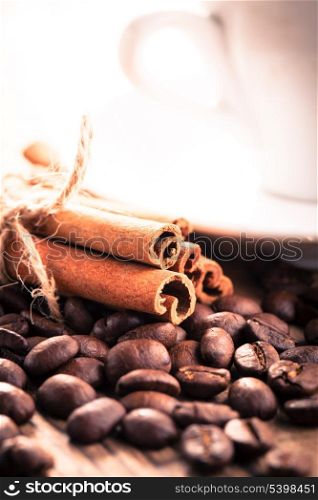 Coffee beans and cinnamon sticks close up