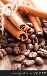 Coffee beans and cinnamon sticks closeup