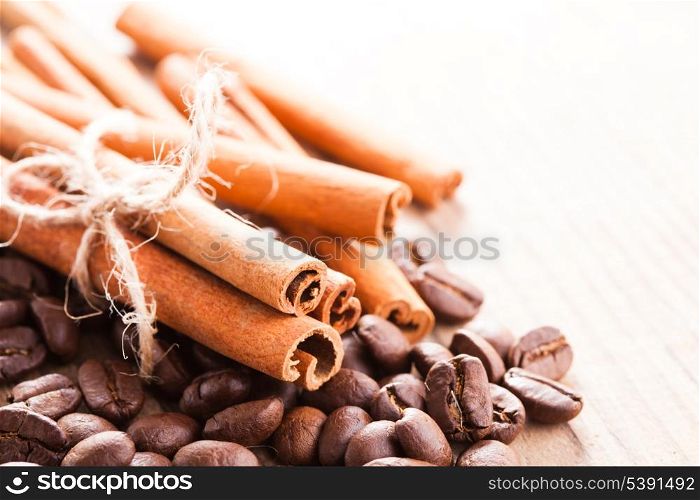 Coffee beans and cinnamon sticks closeup