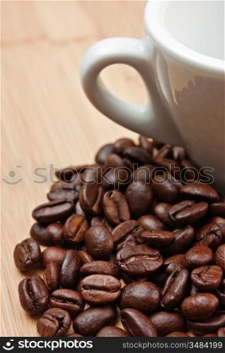 coffee beans and cup on a wooden background