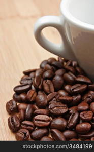 coffee beans and cup on a wooden background