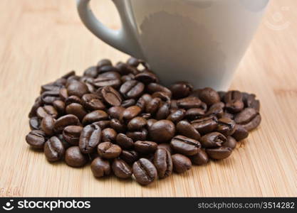 coffee beans and cup on a wooden background