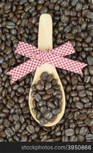 Coffee beans and decorated wooden spoon&#xA;