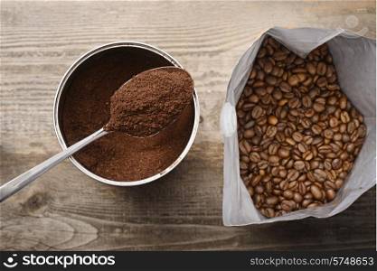 coffee beans and ground coffee on wooden background