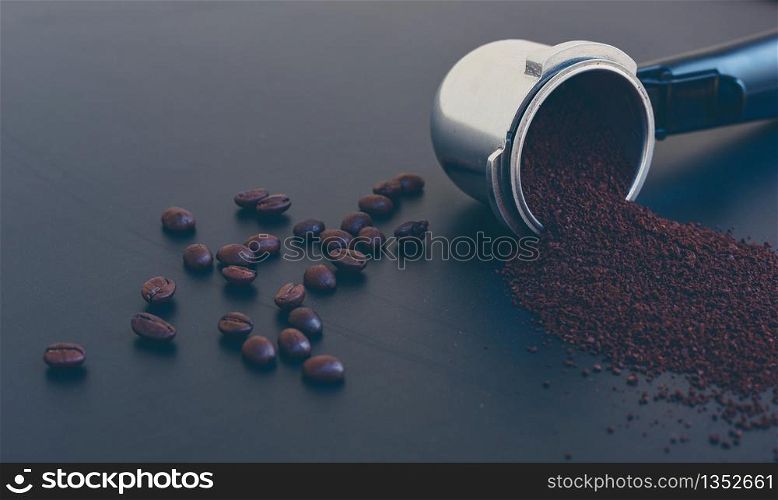 Coffee beans and ground powder on black background. Top view with copy space