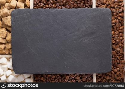 coffee beans and slate stone black tray background, top view