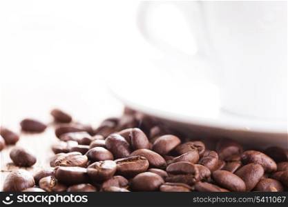 Coffee beans and white cup with copy-space
