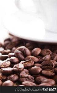 Coffee beans and white cup with copy-space