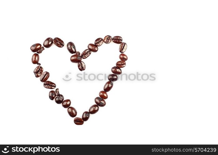 Coffee beans arranged as a heart on a white background