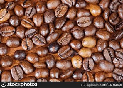 Coffee beans background (focus in the first plane)