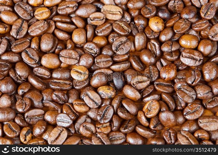 Coffee beans background (focus in the first plane)