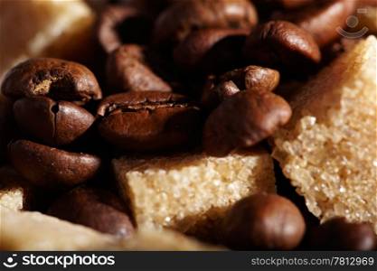 Coffee beans background with brown sugar cubes. Natural morning sunlight.