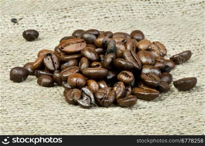 Coffee beans closeup on burlap