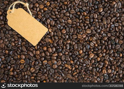 Coffee beans dark and the tag. Top view.. Coffee beans dark and the tag. Top view