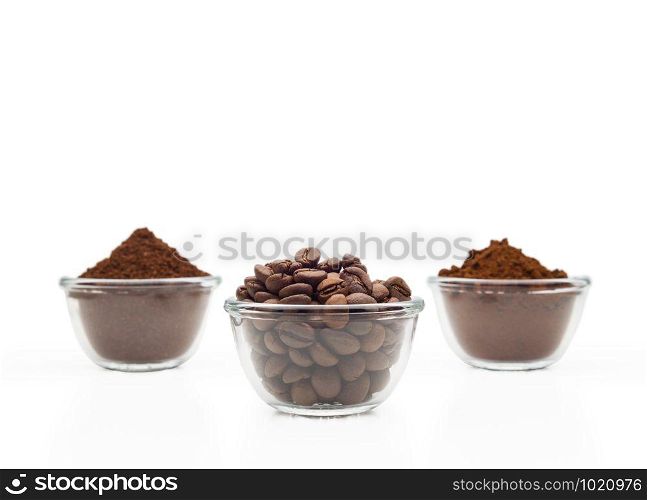 Coffee beans, ground coffee and instant coffee, in little glass cups on a clean white background
