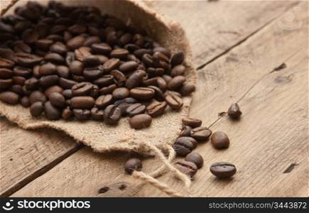 coffee beans in a bag on a wooden background