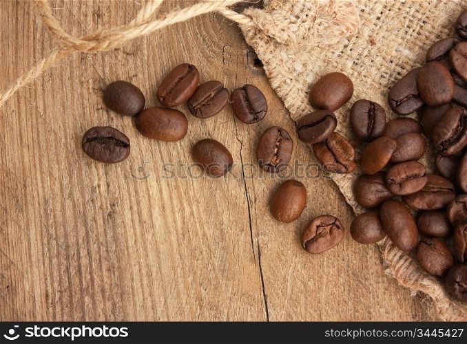 coffee beans in a bag on a wooden background
